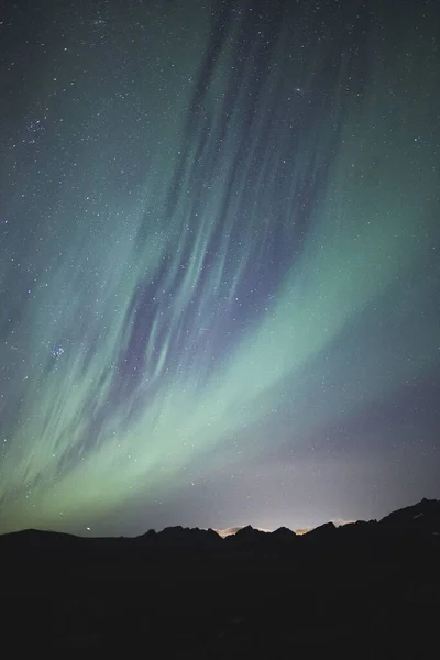 Vertikale Aufnahme eines schönen Polarlichts am farbenfrohen Himmel — Stockfoto