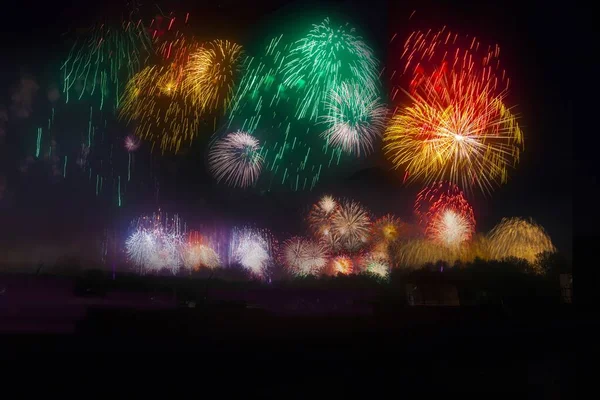 Wide shot of colorful fireworks exploding in the night sky — 스톡 사진