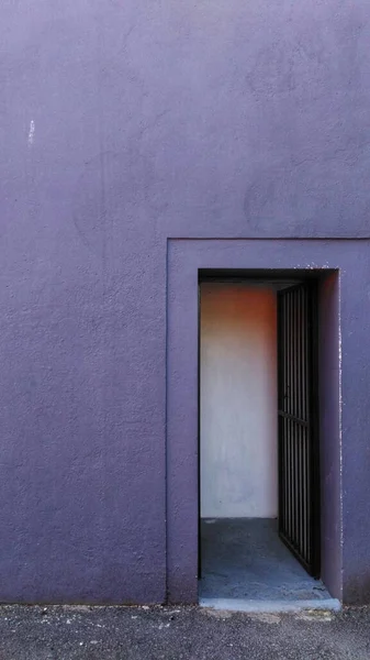 Vertical shot of a purple building with an open door - perfect for a cute background