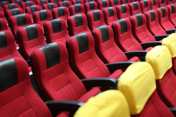 Horizontal shot of an empty cinema hall with red seats — Stock Photo, Image