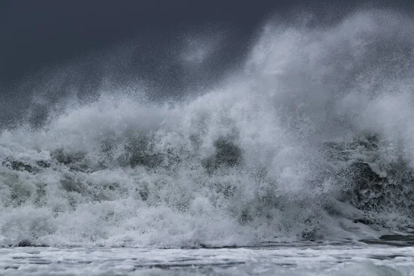 Waves splashing under the dark sky — 스톡 사진