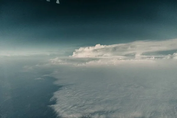 Beautiful shot of clouds with a dark blue sky in the background — 스톡 사진