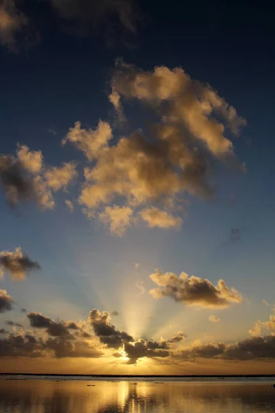 Vertical shot of the magical setting of the sun in Rarotonga