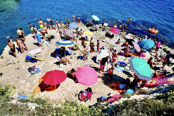 Yüksek açılı çekimde insanlar yaz mevsiminin tadını gündüz vakti suyun yanında çıkarıyorlar. — Stok fotoğraf