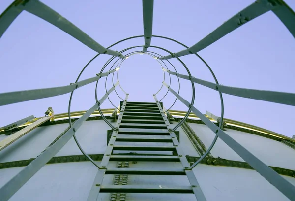 Point of view shot of metal stairs leading up a water tank — Stock Photo, Image