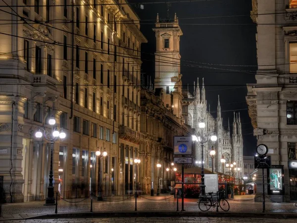 Фотография красивых итальянских многоквартирных домов с уличными фонарями ночью в Милане, Италия — стоковое фото