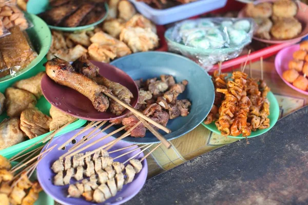 Foto de ángulo alto de deliciosa comida callejera indonesia en platos coloridos — Foto de Stock
