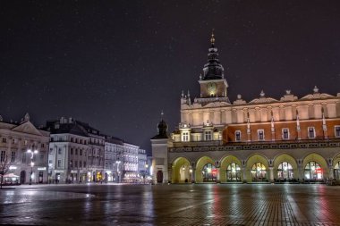 Wide shot of Main Market Square with the tall Town Hall Tower visible in Krakow, Poland clipart