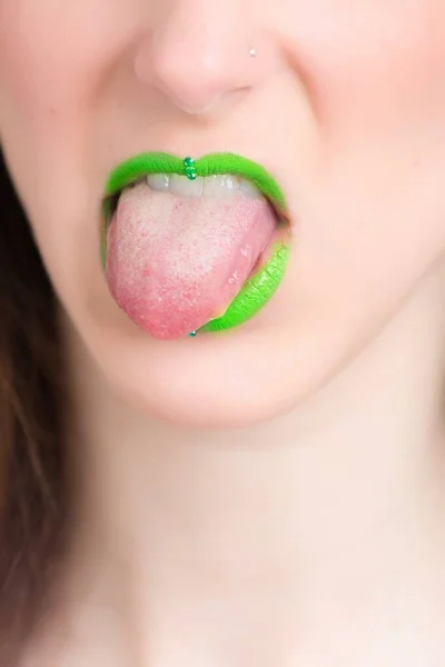 Vertical closeup shot of a female wearing a green lipstick - great for an article about cosmetics — Stock Photo, Image