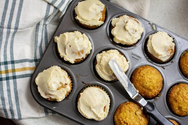 Colpo in testa di muffin al forno con crema in un vassoio grigio di muffin — Foto Stock