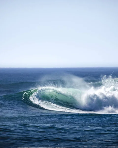 日中に形成される泡と水のボディ内のこぼれる波の曲線の垂直ショット — ストック写真