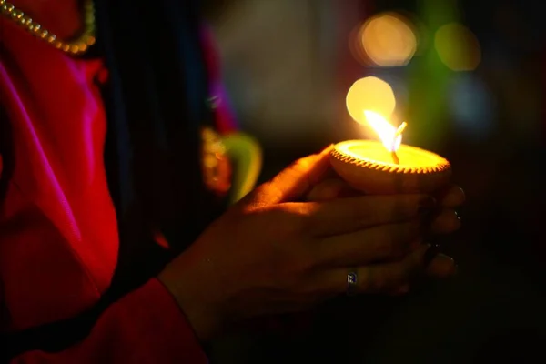 Close-up shot van de handen van een vrouw die een kaars vasthoudt tijdens het Yi Peng festival in Thailand — Stockfoto