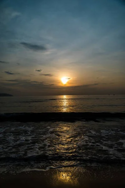 Beautiful vertical shot of the sunset reflected in the sea creating a breathtaking scenery