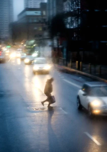 Vertical Blurry Shot Person Running Street Cars Driving Rainy Day — Stock Photo, Image