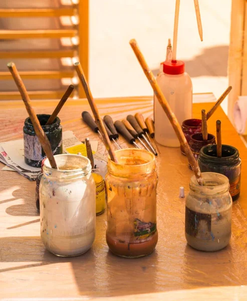 View Bottles Paint Brushes Alongside Painting Objects Placed Surface — Stock Photo, Image