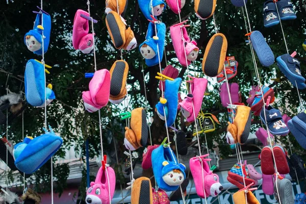 The puffy slippers for children hanging in the store