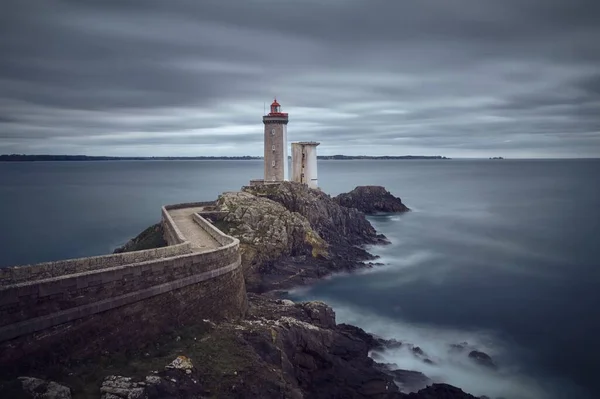 曇った灰色の空の下で海の美しい景色を望むフランスのプチミヌー灯台 — ストック写真