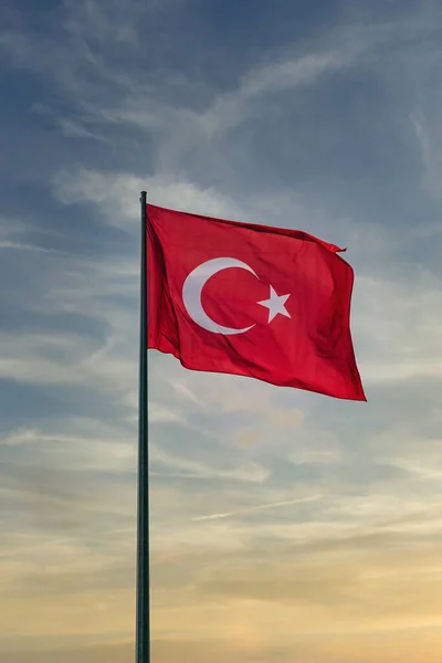A vertical closeup shot of a flag of turkey at sunset