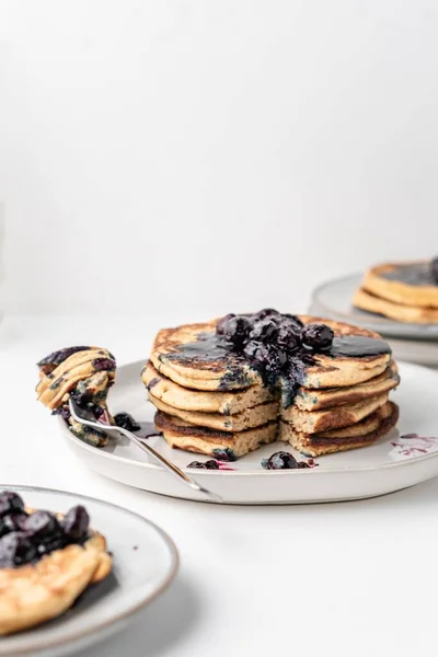 The fluffy blueberry pancakes for breakfast on the white table