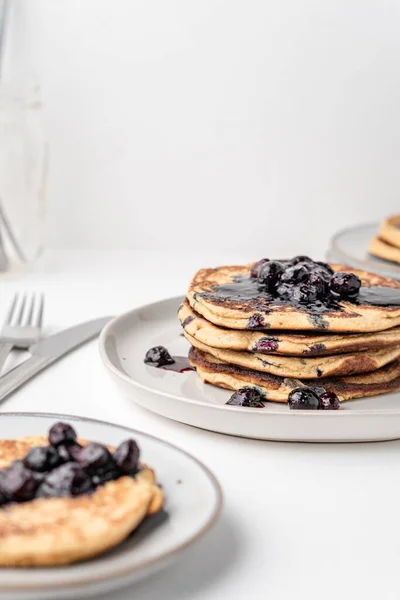 The fluffy blueberry pancakes for breakfast on the white table