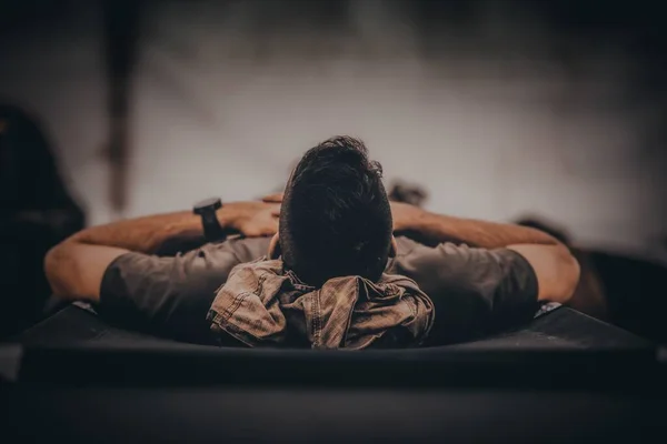 A closeup shot of a soldier sleeping in bed