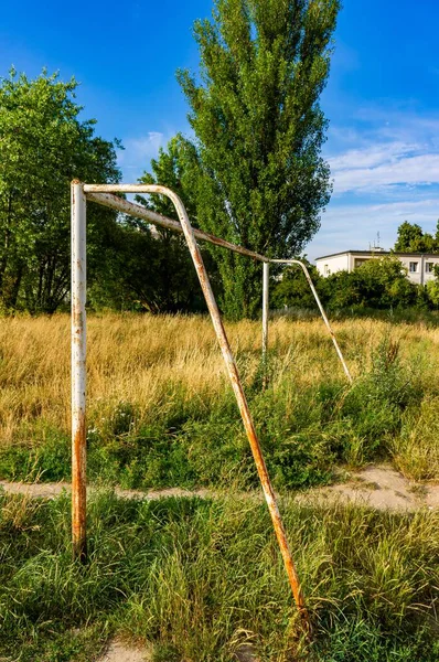 Pionowy Strzał Zardzewiałego Starego Gola Trawiastym Polu Otoczonym Drzewami — Zdjęcie stockowe