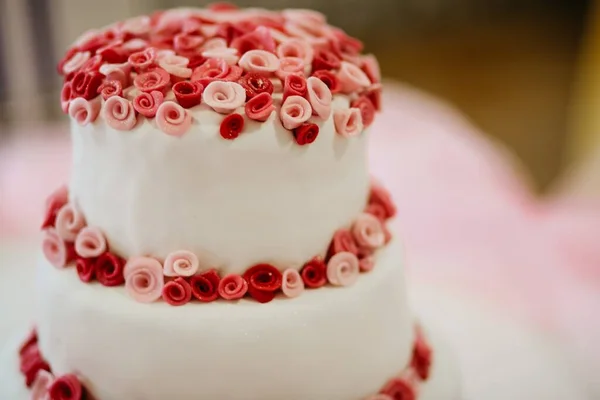Płytkie Ujęcie Ostrości Białego Tortu Weselnego Ozdobionego Małymi Czerwonymi Różowymi — Zdjęcie stockowe