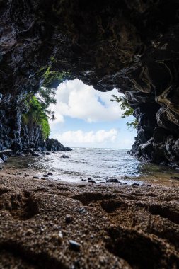 A vertical shot of the rocky Turtle Cove in North Shore, Kauai, Hawaii clipart