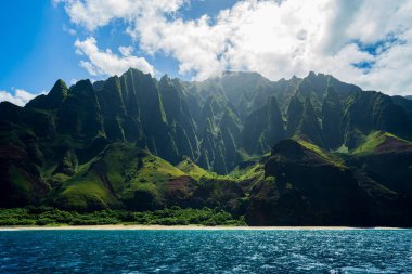 A beautiful scenery of rocky cliffs on Napali Coast, Kauai, Hawaii on a sunny day clipart
