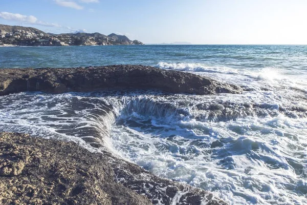 Bliskie Ujęcie Piankowych Fal Niebieskiego Oceanu Skalistej Powierzchni — Zdjęcie stockowe