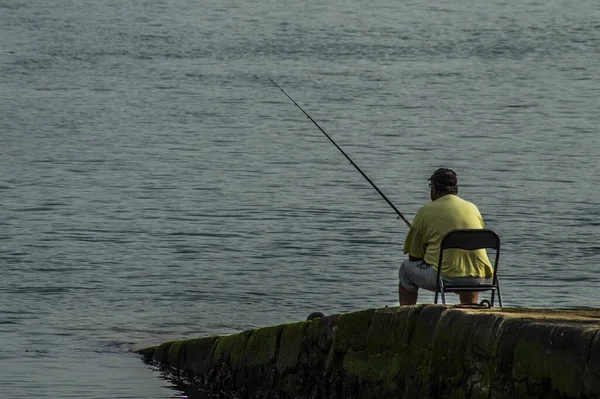 Man Relaxing Fishing Moss Covered Coast Side — Stock Photo, Image