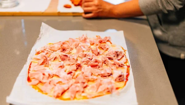 Person Making Pizza Adding Ingredients Kitchen — Stock Photo, Image