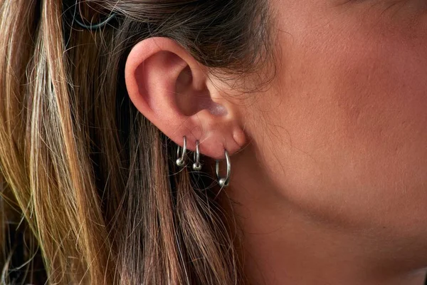 Closeup Shot Female Triple Earrings — Stock Photo, Image