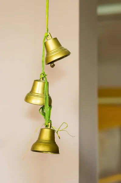 Vertical Selective Focus Shot Golden Bells Hanging Green String House — Stock Photo, Image