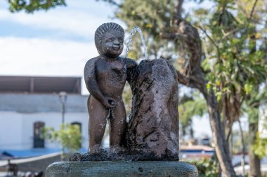 OCOTLN DE MORELOS, OAXACA, MEXICO - Jan 03, 2020: A fountain statue of a boy urinating or peeing.  clipart