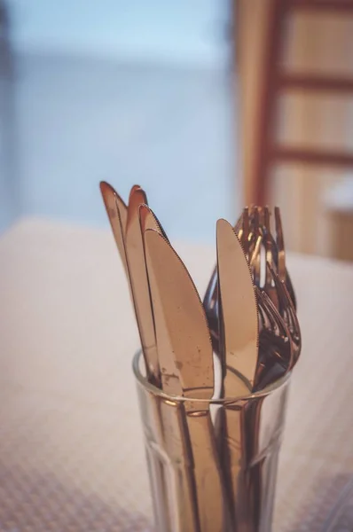 Vertical Shot Metal Forks Knives Glass White Surface — Stock Photo, Image