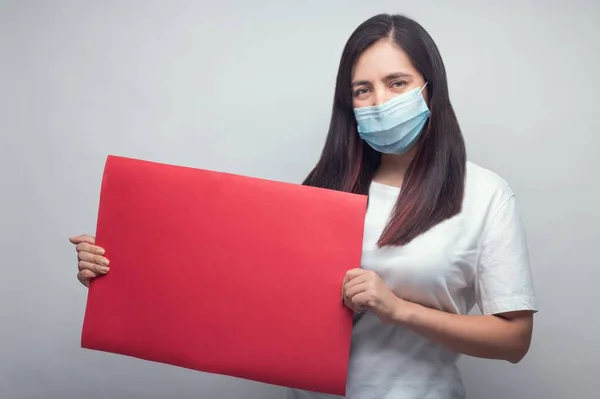 Een Blanke Vrouw Een Gezichtsmasker Met Een Rood Rechthoekig Bord — Stockfoto