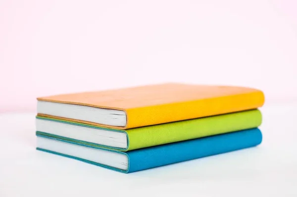 Closeup Orange Green Blue Books Placed Each Other White Background — Stock Photo, Image