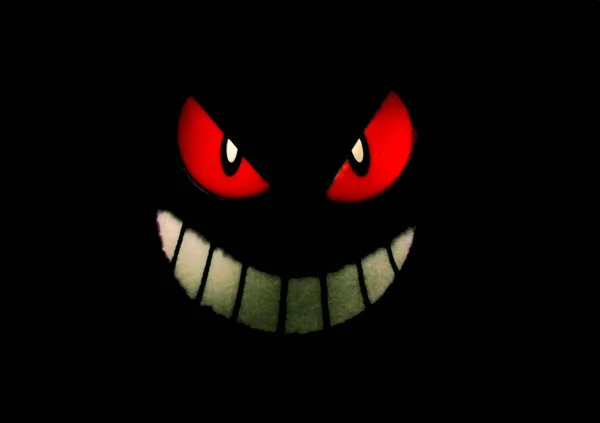 An isolated illustration of an evil face with red eyes and a sinister smile