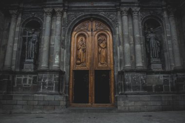 A beautiful shot of a wooden entry door with religious architecture clipart