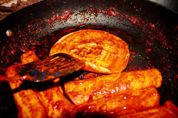 The process of cooking Mexican traditional dish enchiladas with cheese and potatoes