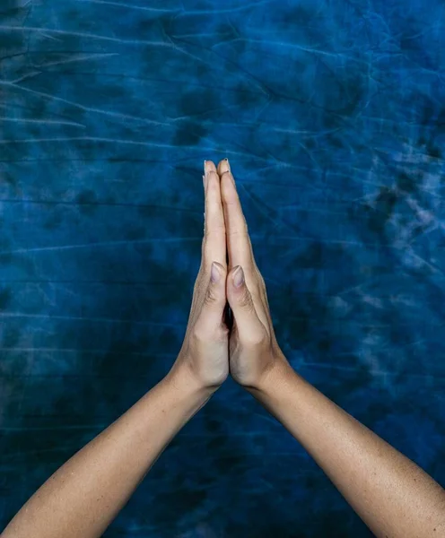 Vertical Shot Two Hands Pressed Each Other Marble Blue Background — Stock Photo, Image