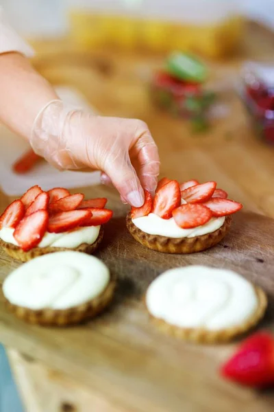 Baker Putting Strawberries Small Strawberry Pies Whipped Cream — Stock Photo, Image