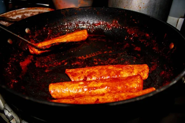 The process of cooking Mexican traditional dish enchiladas with cheese and potatoes