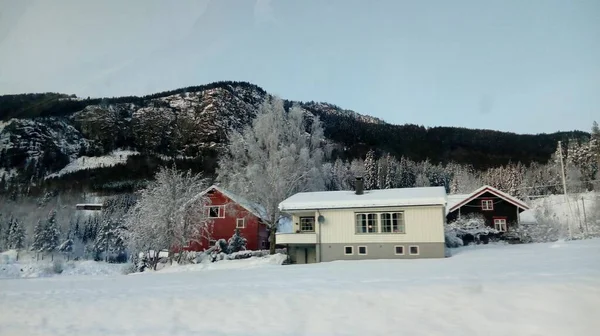 Três Pequenas Casas Frente Montanhas Cobertas Neve — Fotografia de Stock