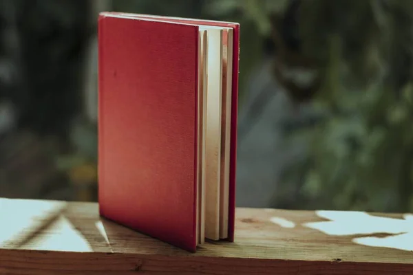 Close Livro Com Uma Capa Vermelha Uma Cerca Madeira Jardim — Fotografia de Stock