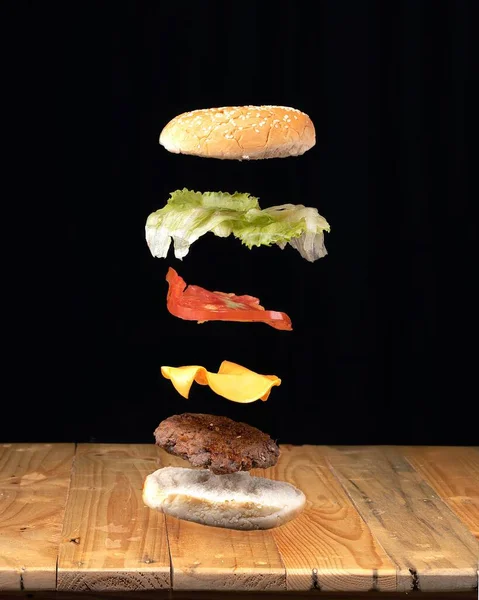 Ein Köstlicher Hamburger Mit Realistisch Fliegenden Zutaten Das Konzept Der — Stockfoto