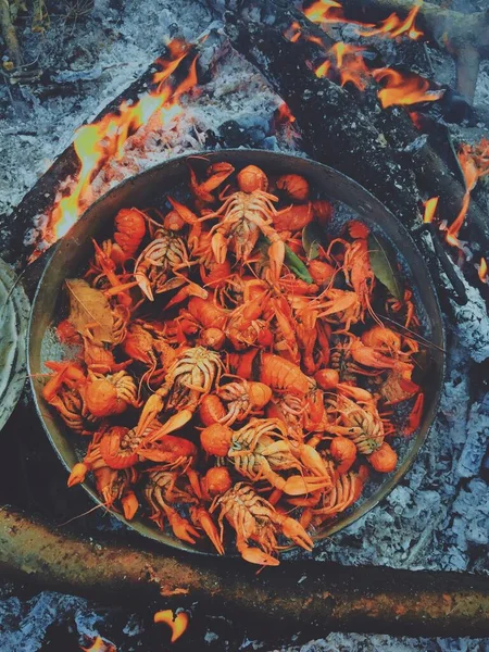Cooked red crawfishes in the pot on the fire