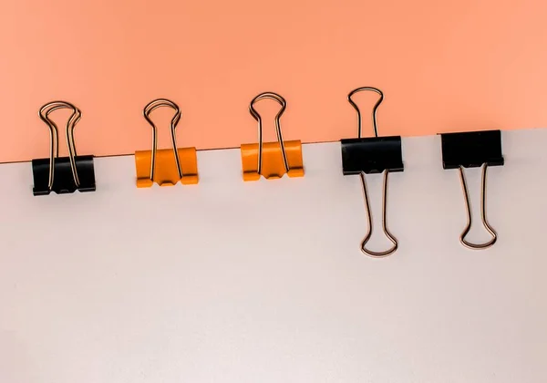 Closeup Shot Orange Black Binder Paper Clips Attached White Papers — Stock Photo, Image