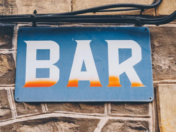 Closeup Shot Rusty Blue Bar Sign Hanging Wall — Stock Photo, Image